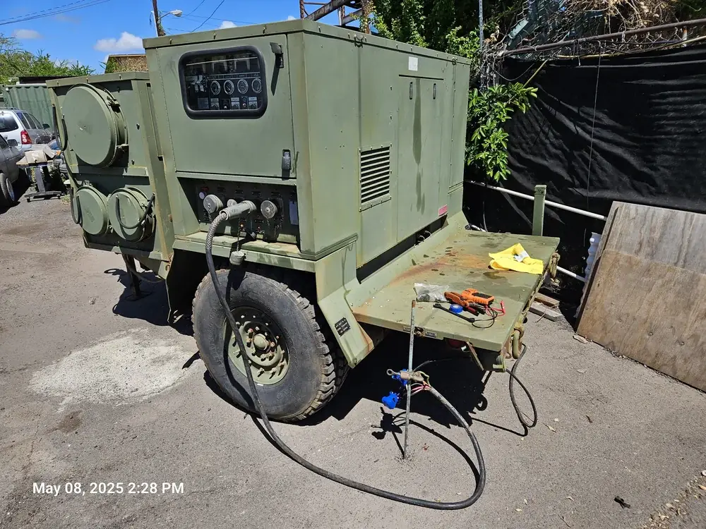 Green trailer generator being serviced