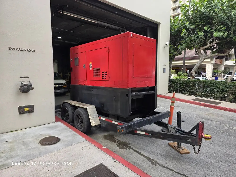 Red generator on a trailer inside a covered building