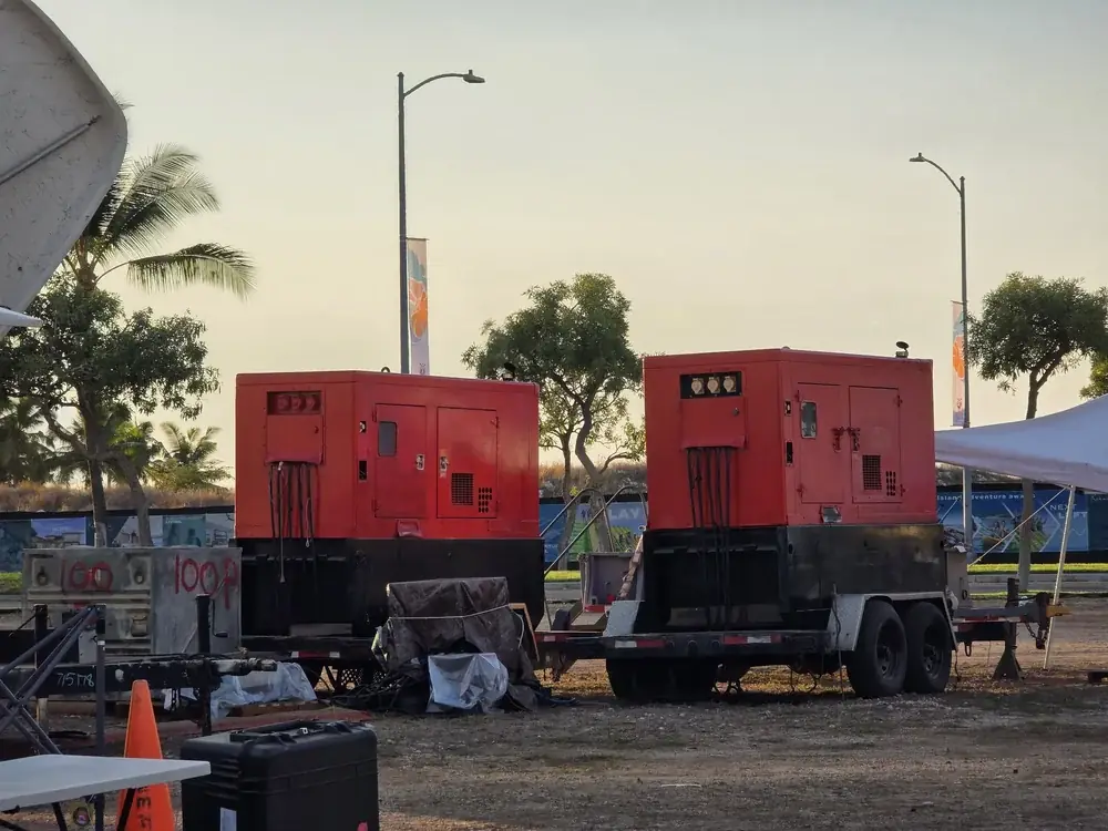 Two red Central Pacific Power trailer-mounted diesel generators set up on a job site